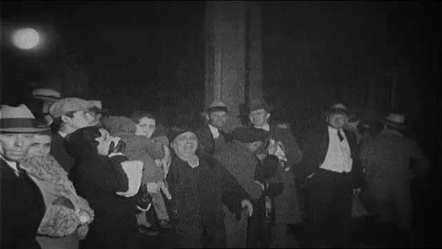 1930s: A woman gestures and laughs as. a crowd waits on a train platform. Title card. Crowd in the stands of a football stadium.