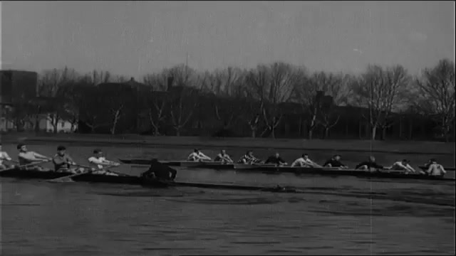 1930s: Franklin Roosevelt Jr. rows crew. King Gustav holds a tennis racket and wears a coat. He removes his hat. Womaen sit and watch. Gustav plays tennis. 