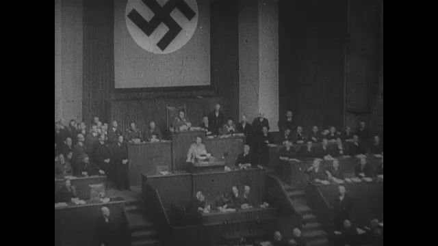 1930s Germany: Adolf Hitler speaks to assembly of men and officers at Reichstag.