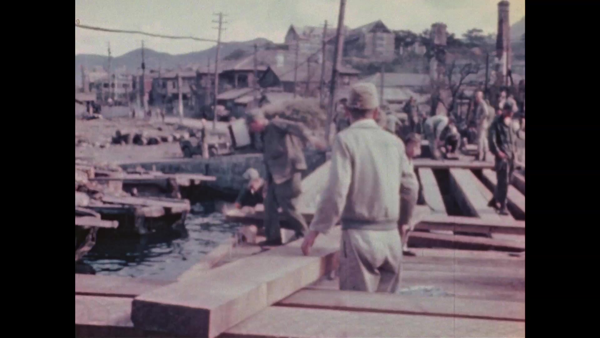 1940s Nagasaki: Neighborhood, water, power lines. Soldiers build bridge ...