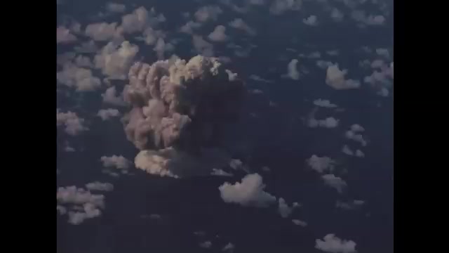 1940s Bikini Atoll: bomb denoting in ocean and forming mushroom cloud