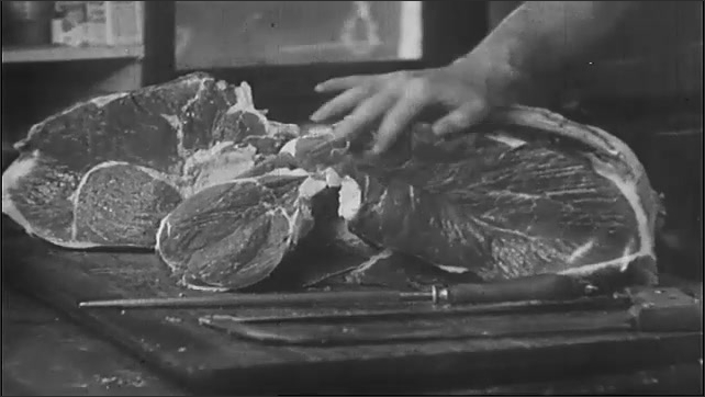 1930s: Doctor uses a swab to clean a man's eye. Cook cuts a slice from a side of beef. Man eats from a tin plate meat and potatoes. Title card.