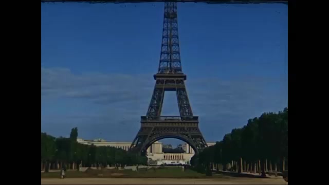 1940s: Eiffel Tower, car driving past Eiffel Tower, taking elevator up Eiffel Tower