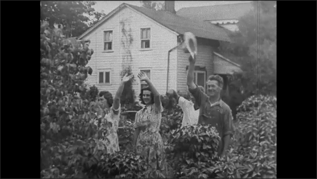 1940s: Men load baskets of beans into truck. Cars pull away from house, people waving. People waving in yard. Close up of man talking in microphone. Man talking. Intertitle.