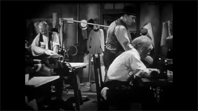 1910s: People look through stalls on the sidewalk. 1950s: Foreman visits workers in a small garment shop. Man sews. Man uses a sewing machine. Man puts clothes on a form. Two men at sewing machines.