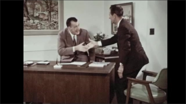 1960s: Man signs paper and hands it to man. Men stand and shake hands. Man touches car.