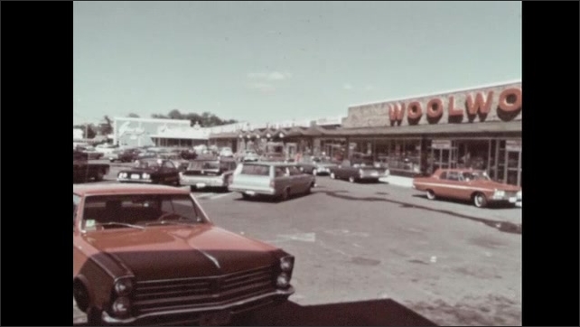 1960s: Men talk. People at work on factory floor. Wholesale and retail establishments. Woolworth's store. Gas station.