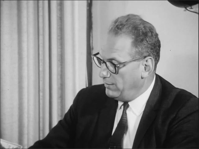 1960s: Dr. Cecil Thomas speaking to interviewer. Men sitting around a desk, congressman Willis speaks.