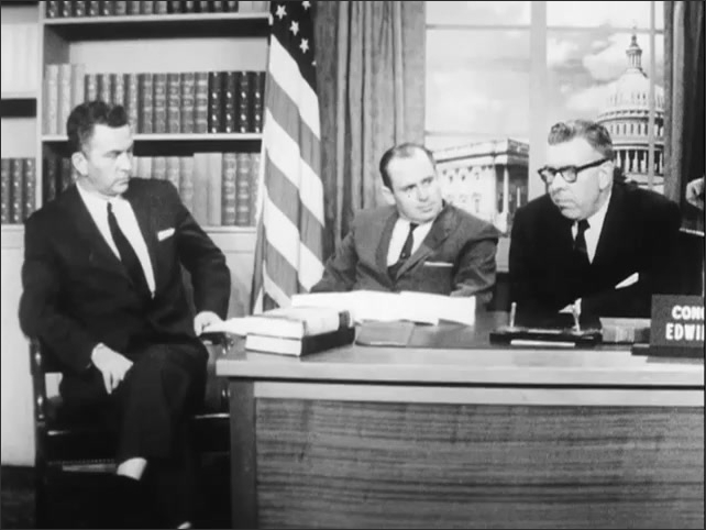 1960s: Congressman Willis speaking at a desk, other men listening.