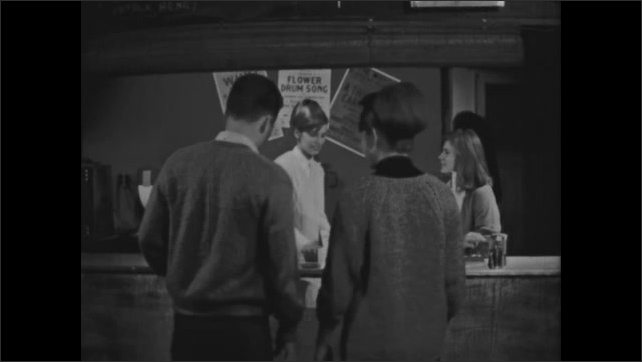 1960s: Girl pulls out coffee urn and begins making coffee. Percolator is turned on and begins bubbling. Girl pours coffee for patron. Man in suit is interviewed inside coffeehouse.
