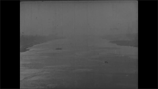 1930s: Manhattan skyline, titles. Long shot of New York City, pan across Hudson River. View of Hudson River. 