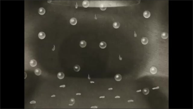 1930s: Animated diagram of a manifold. Liquid fuel vaporizes while bubbles flow in either direction. Manifold on an engine. Vaporized fuel flows through a pipe.