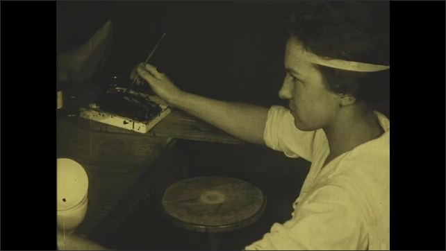 1910s: Woman showing decals applied to bowl. Title card. Woman painting cups and saucers.