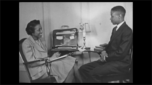  1940s:  Caption reads "THEY ARE INTERVIEWED BY HAMPTON'S COUNSELLOR."  Young man and woman speak in office.  Caption.  Men open door and enter office.