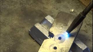 Cleaning lead off a bullet mold with a torch