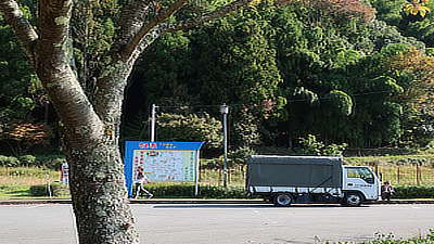 A truck parked at a roadside stop.