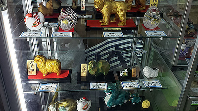 Figurines in a display case in a shop.