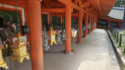 Metal lanterns along the outer walls of a shrine.