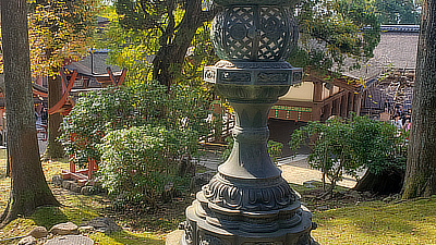 A stone lantern in the courtyard of a shrine.