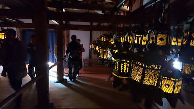 A view of the entrance where people come and go through a darker area, showing some of the lanterns.