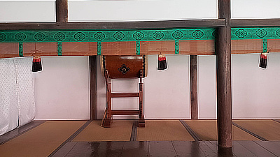 A drum on display in a room with tatami mats. 