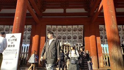 People walking around outside one of the gates in front of Todaiji.