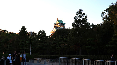 The first glimpse of Osaka Castle in the setting light.