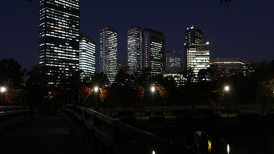 Osaka at night as seen from a bridge leaving Osaka Castle.