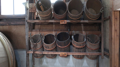 Barrels in a wooden shelf.