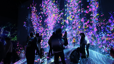 People take pictures in the "Universe of Water Particles on a Rock where People Gather" exhibit.