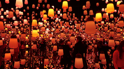 People take photos while passing through the "Forest of Lamps" exhibit.