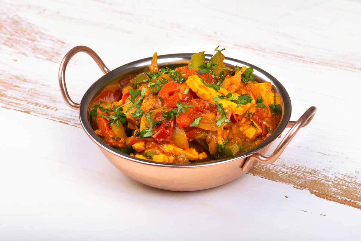Pot of jalfrezi curry with paneer cheese