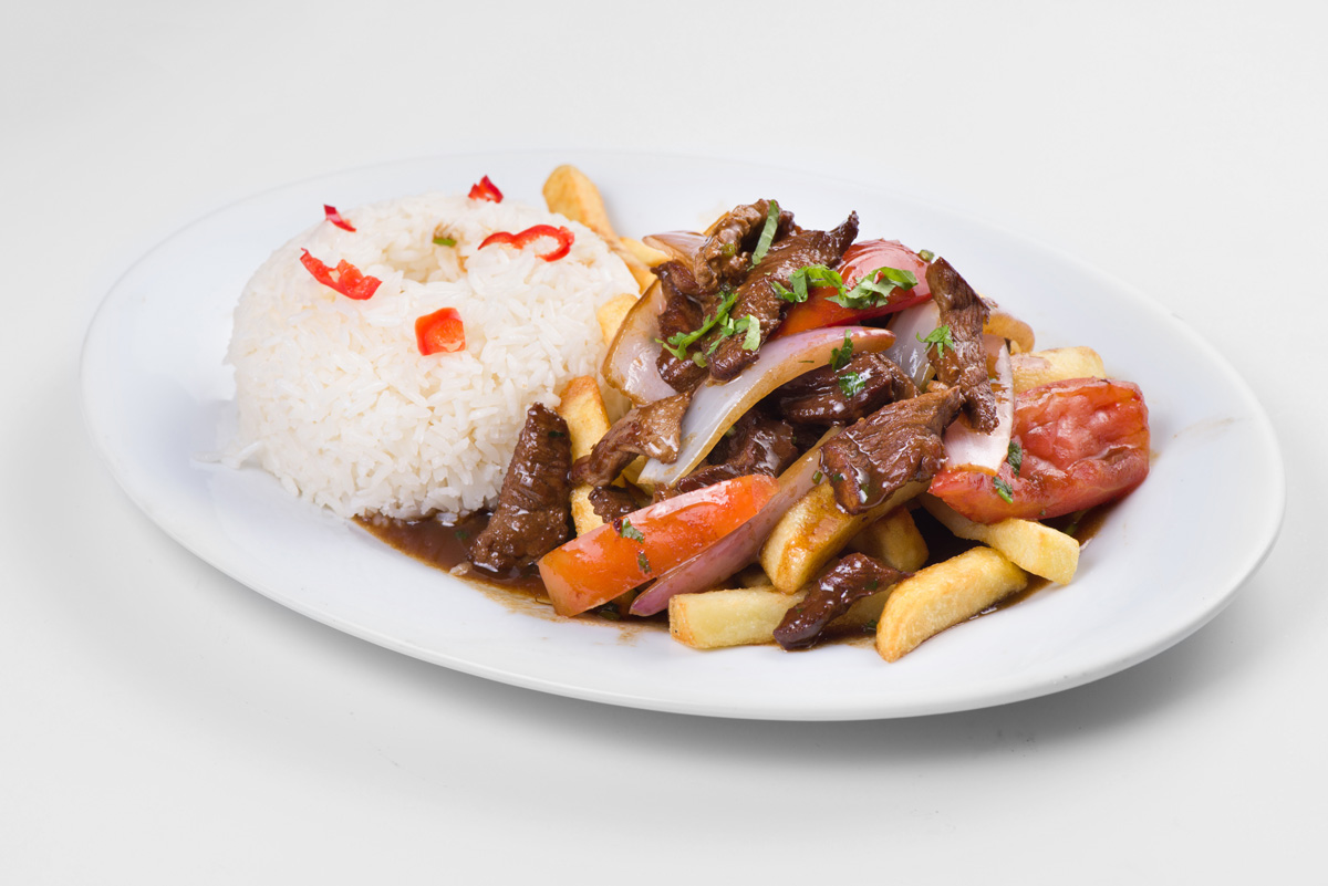 Peruvian lomo saltado stir fried pork with fries and rice