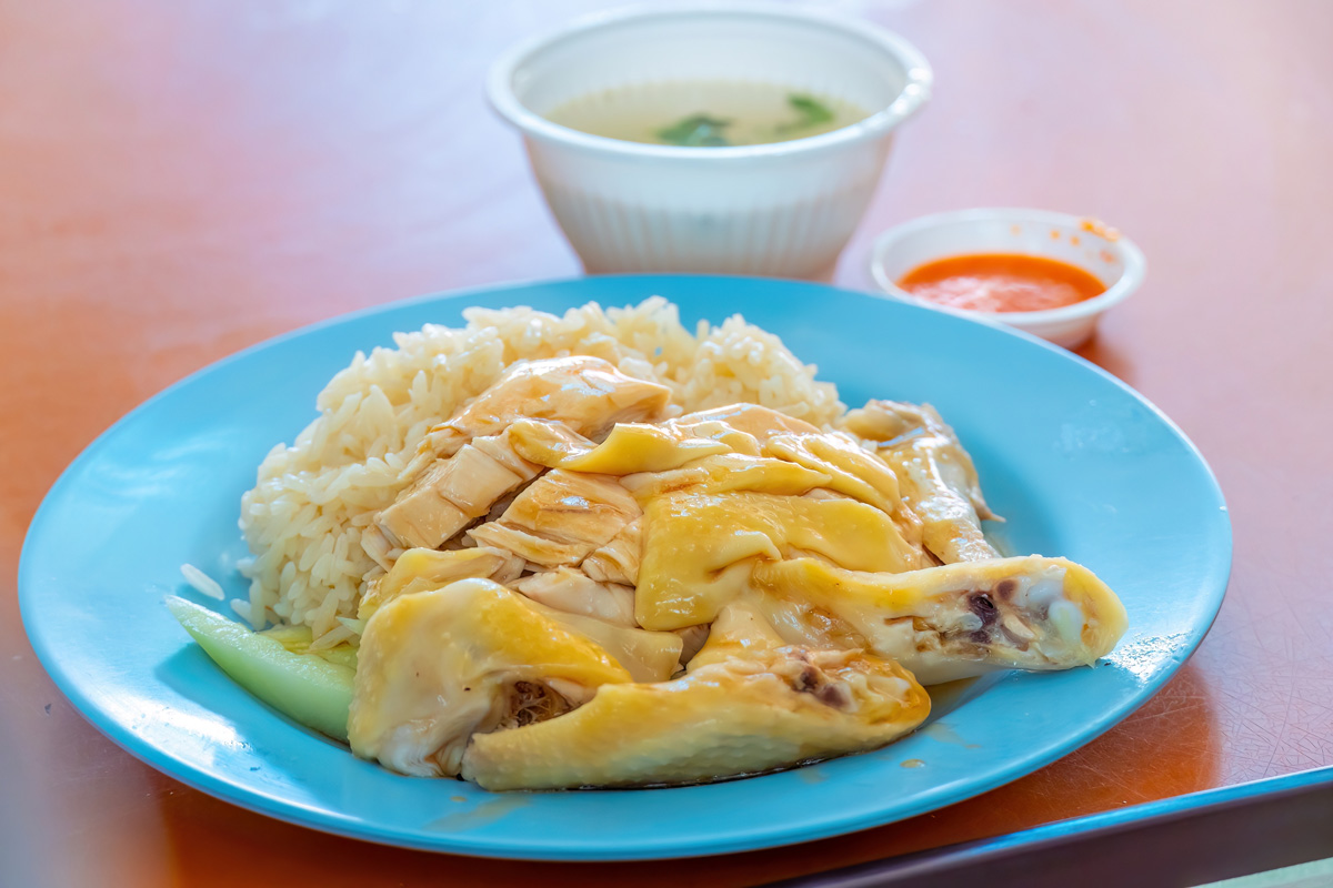 Plate of Hainan chicken rice with sauce