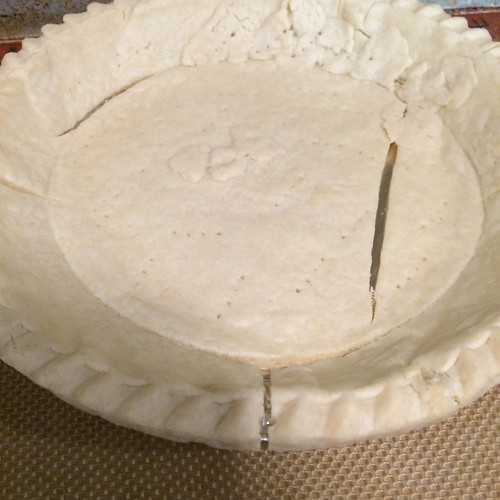 A baked pie crust containing three large cracks; not suitable for quiche.