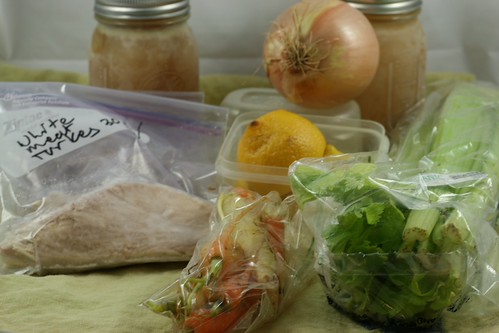 The ingredients for lemon-turkey soup. Two jars of homemade stock, celery, lemons, carrots, and turkey.
