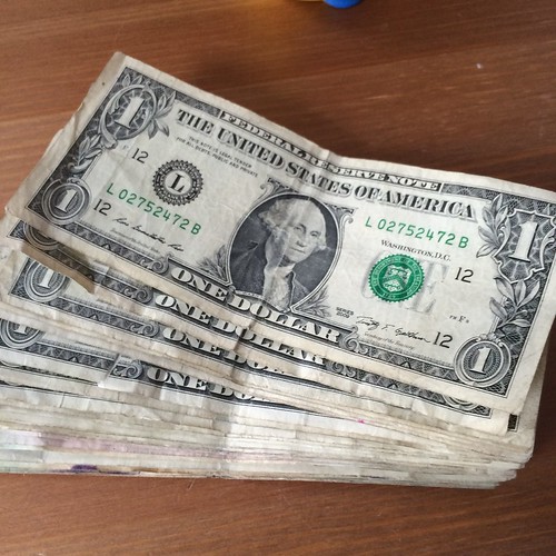 A pile of one dollar bills.