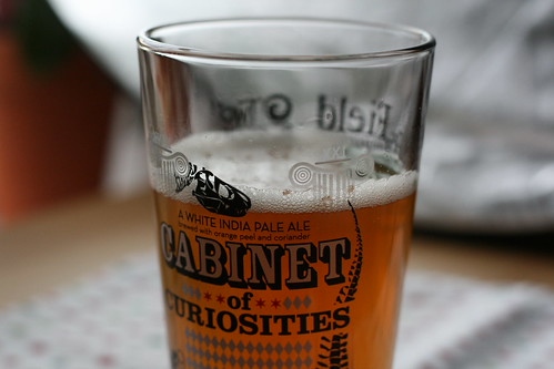 What appears to be beer in a glass labeled