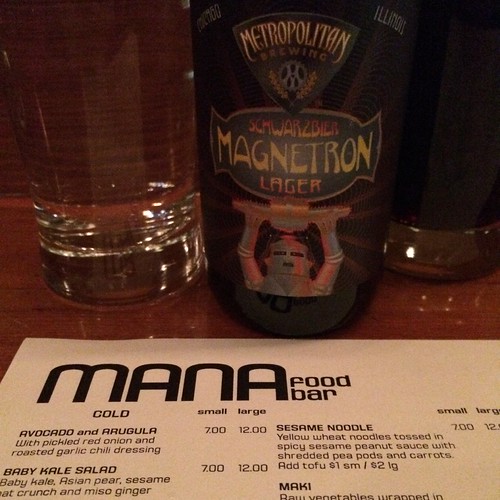 A bottle of Metropolitan Brewing's Magnetron above a MANA menu.