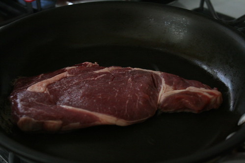 Ribeye in pan.
