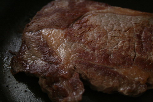 Seared ribeye in pan.