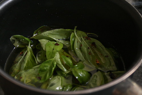 Infusing olive oil with basil & red pepper.
